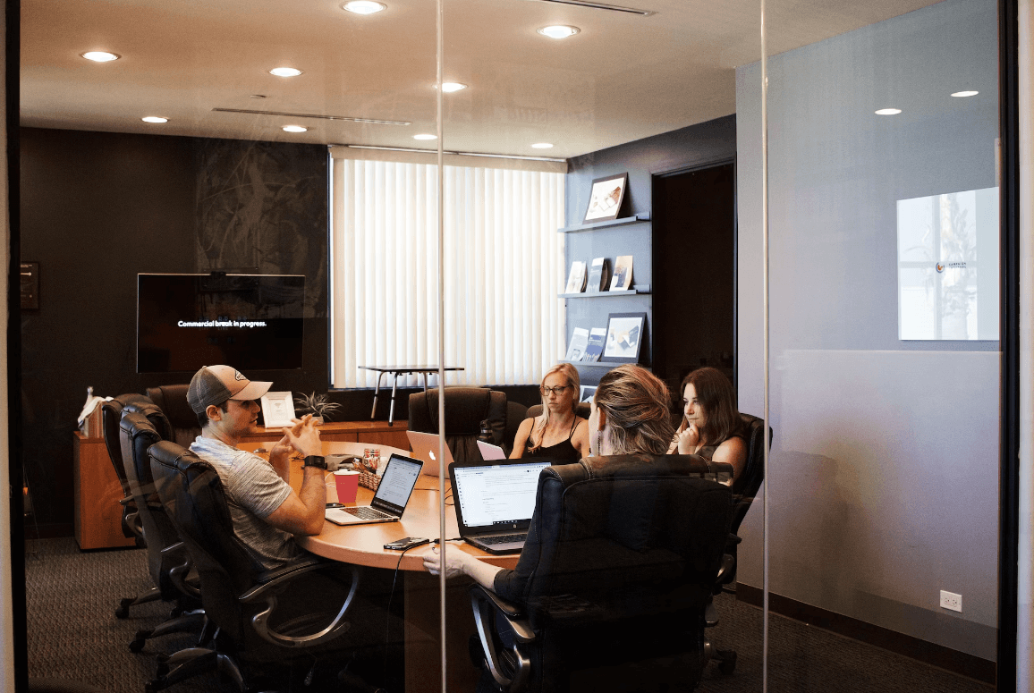 Office meeting room with team members around a table